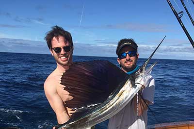 Holding Fish at Sunset